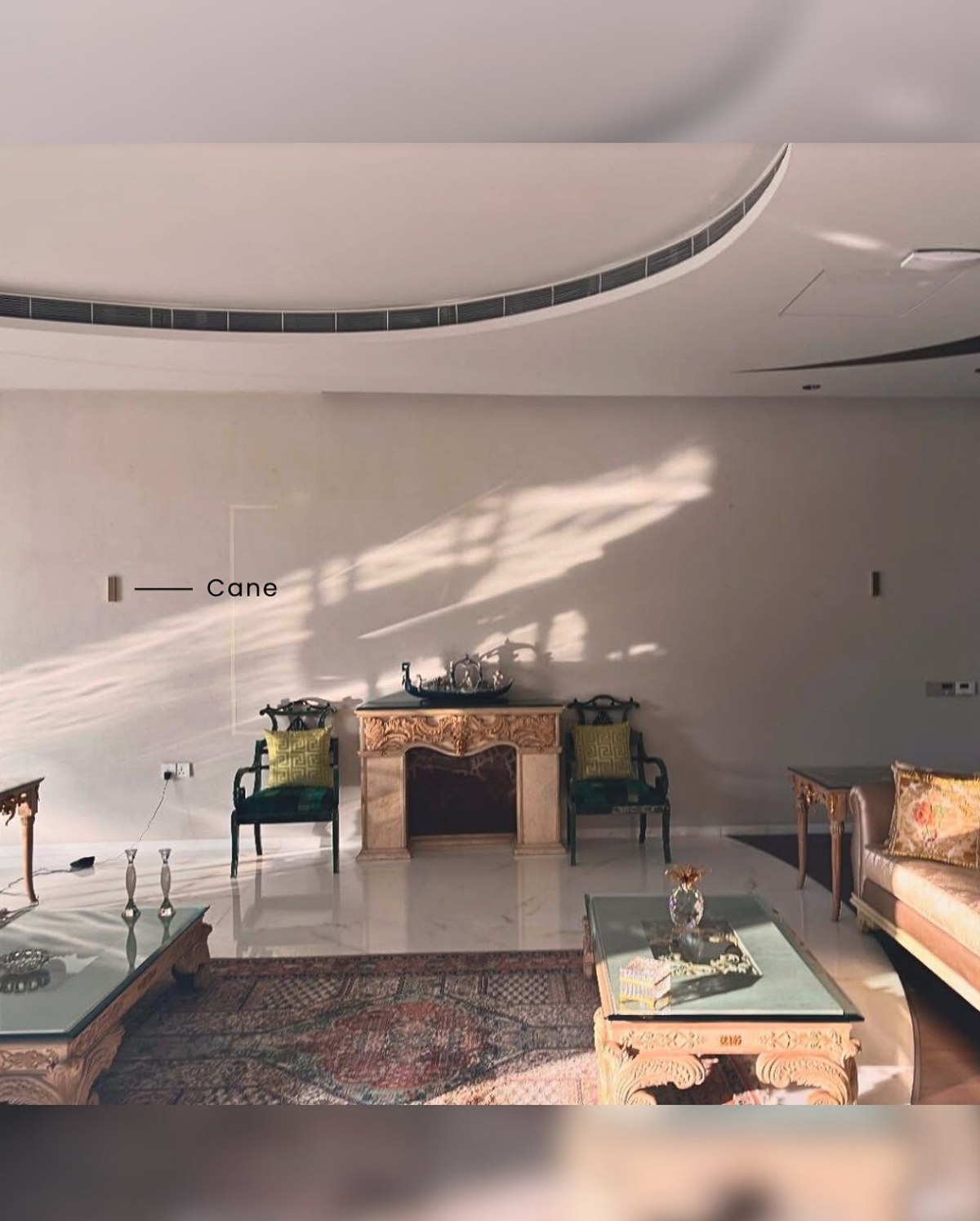 Formal hotel lobby with a marble fireplace and XSCACE Cane speakers mounted symmetrically beside the mantel
