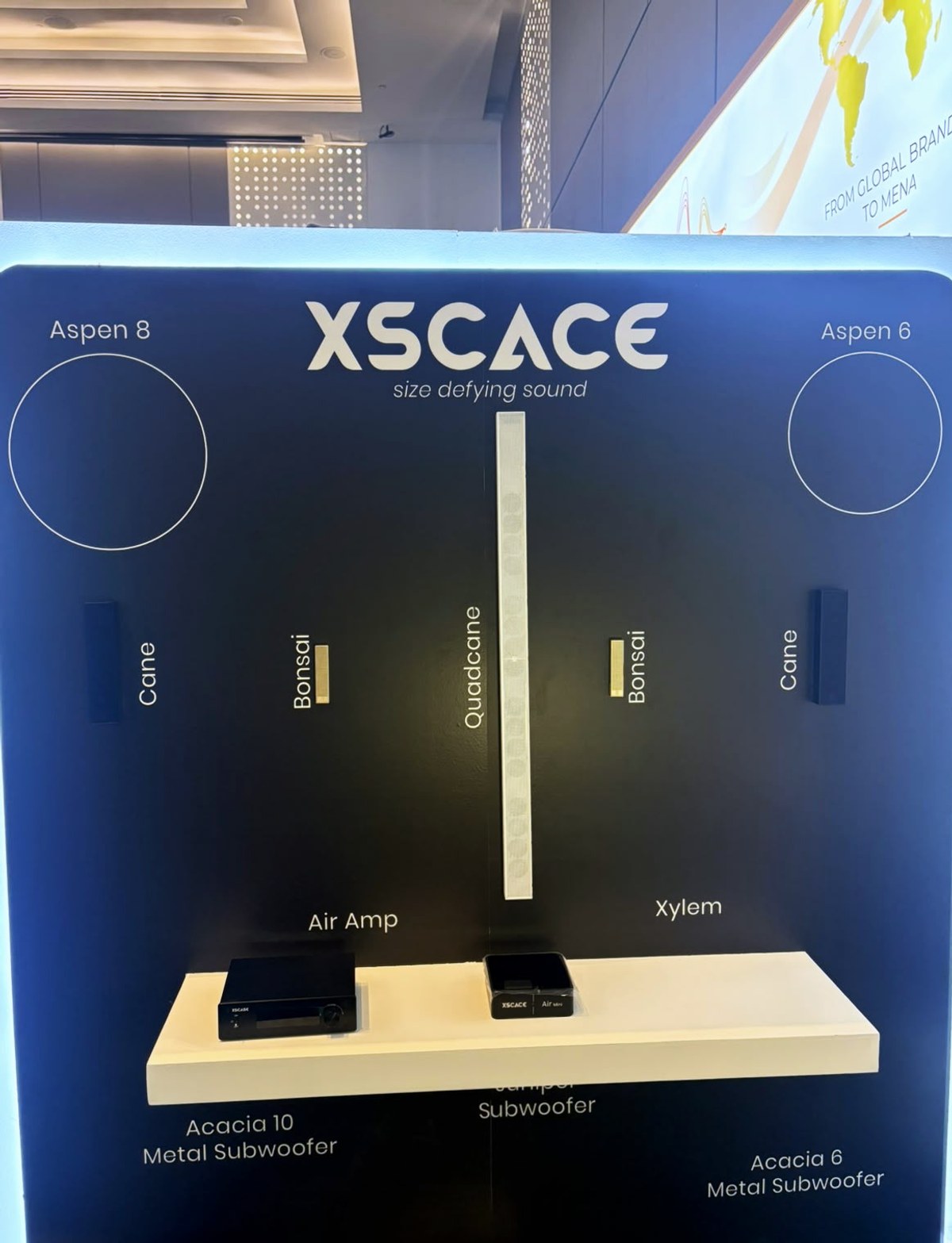 The XSCACE product wall at the High End and Smart Home Show 2026 in Dubai, showing Aspen 8, Aspen 6, Cane, Bonsai, QuadCane, Air Amp, Xylem, Acacia 10, Juniper and Acacia 6