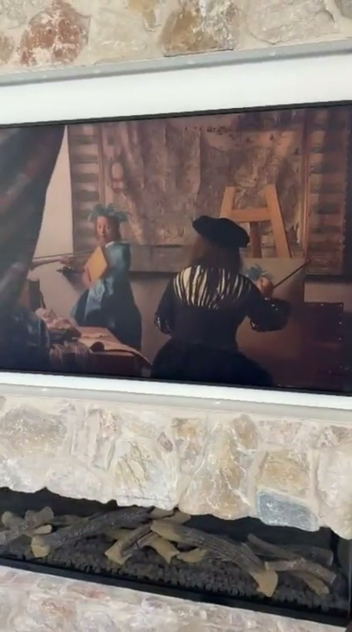 The QuadCane beside the framed painting on the stone wall