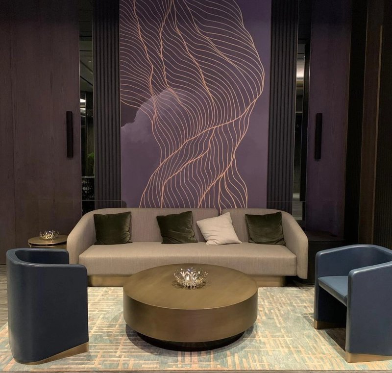 Two XSCACE Cedar speakers symmetrically flanking a wall mural on fluted dark wood pilasters