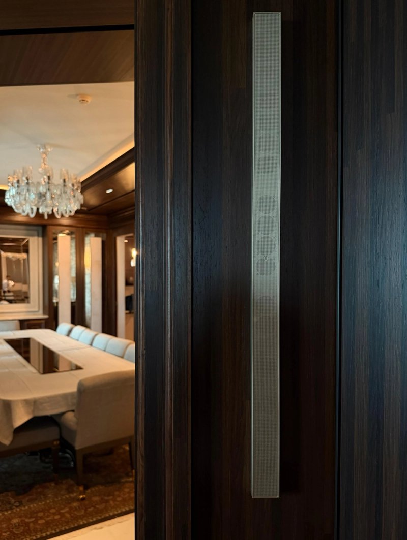XSCACE QuadCane speaker flush-mounted into rich mahogany wood panelling in a formal dining room