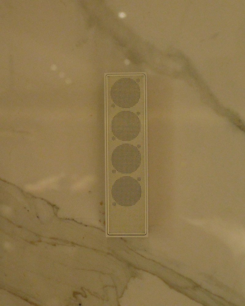XSCACE Cane speaker mounted on a woven fabric wall panel in a formal private dining room