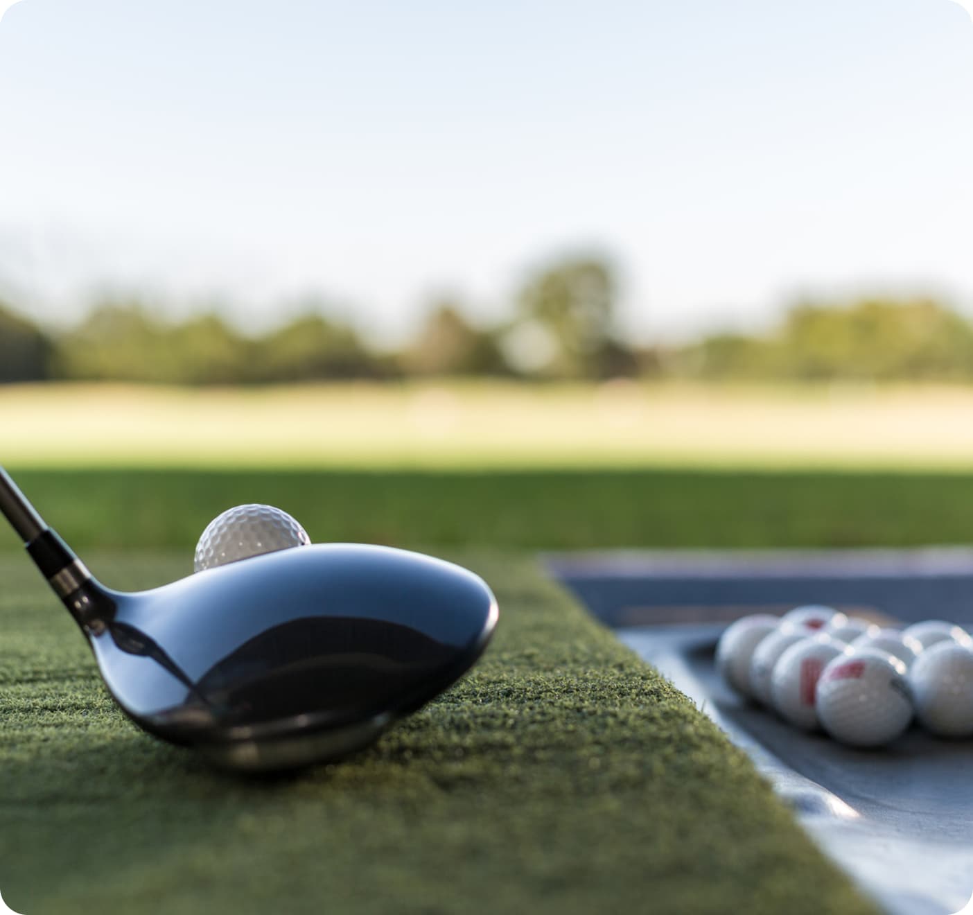Head of a golf club near a ball