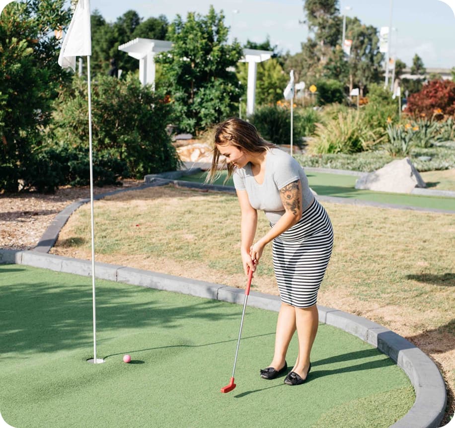 Woman playing mini-golf