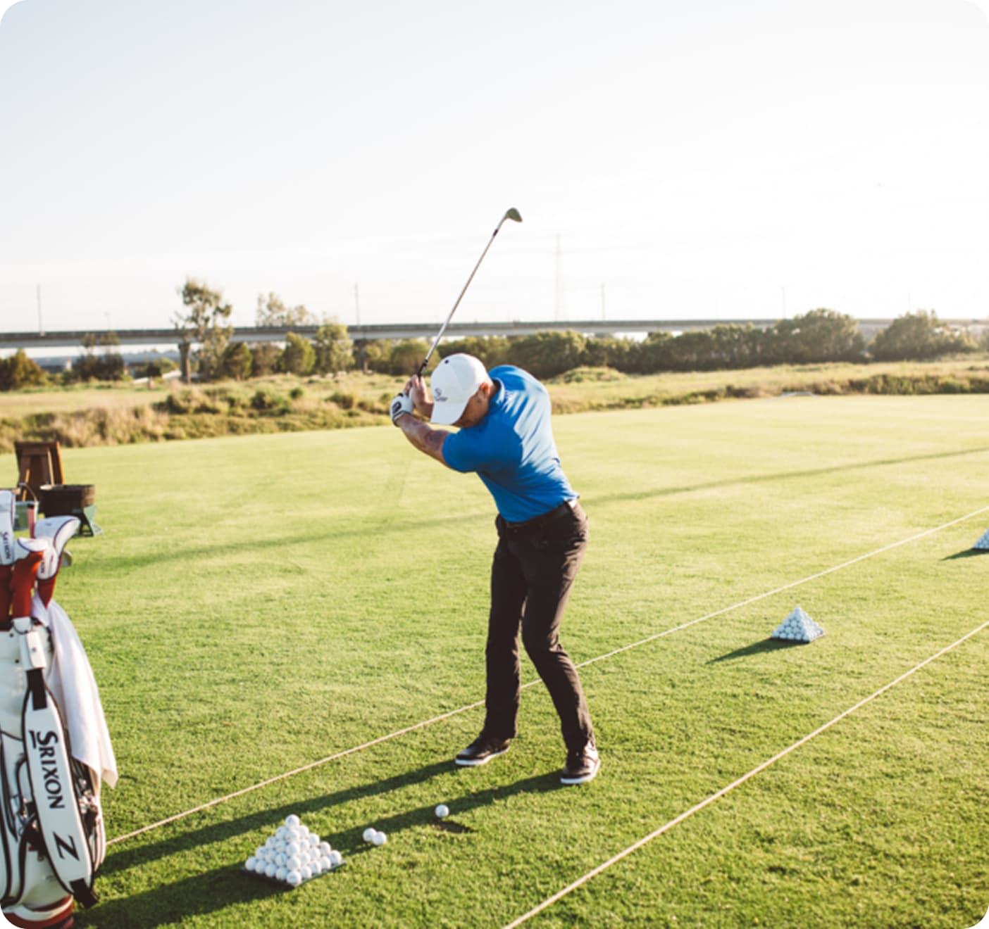 Man Swinging Golf Club