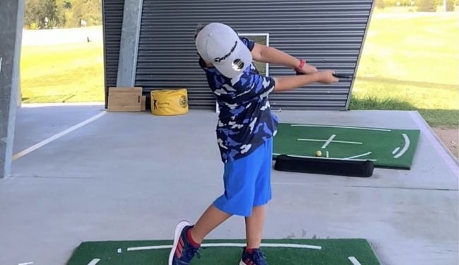 Kid playing golf