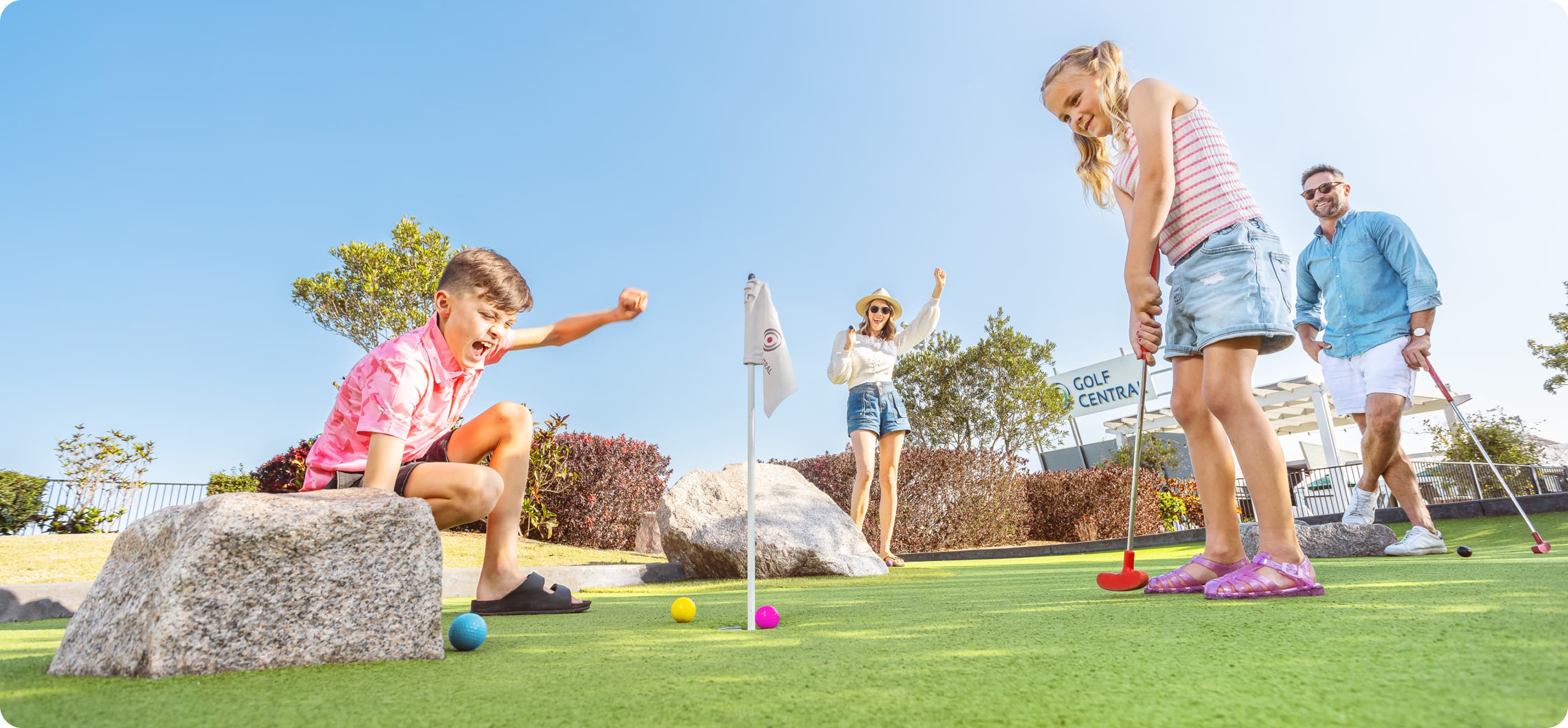 Kids playing mini golf
