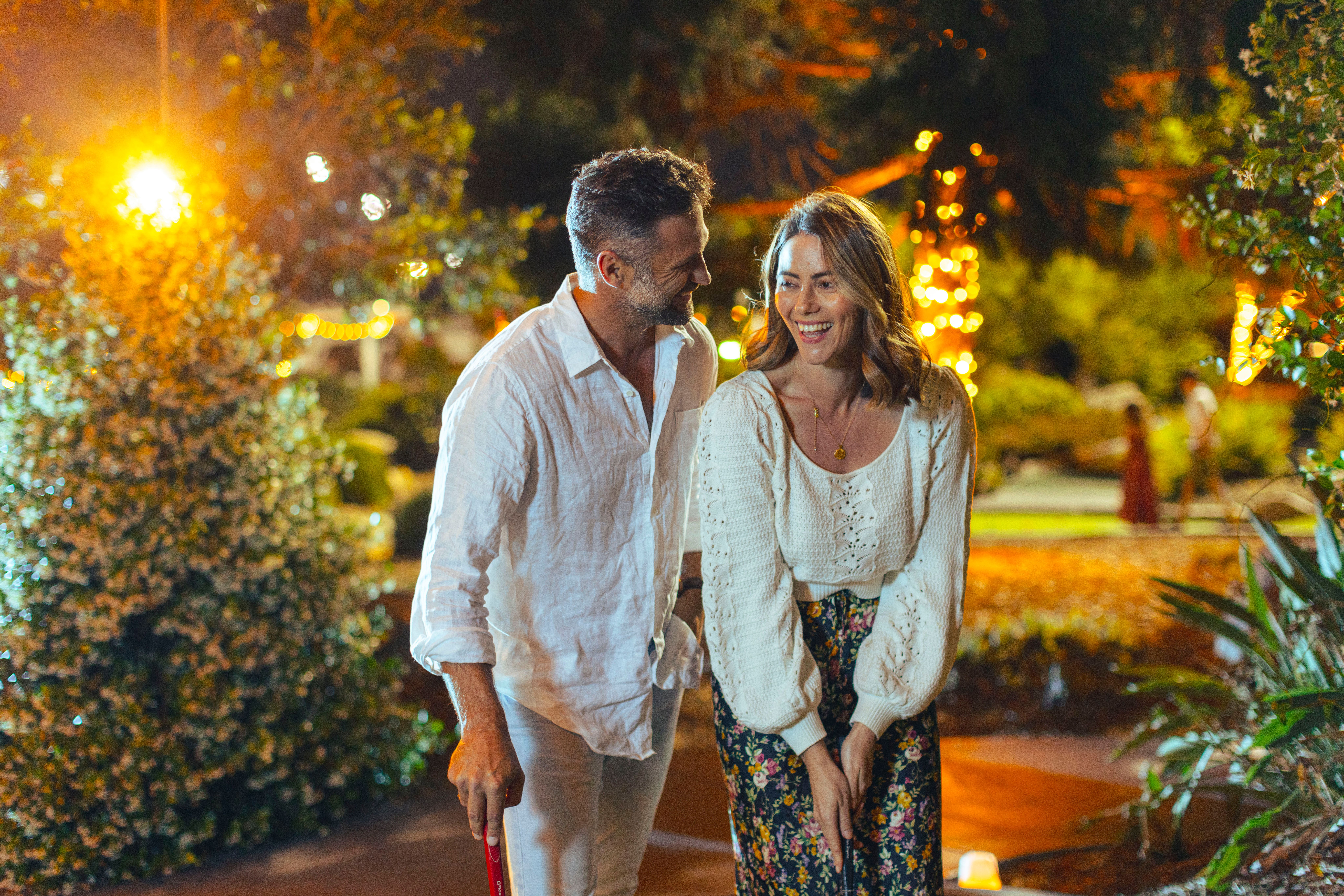 PGA coached lesson, man in blue kneeling