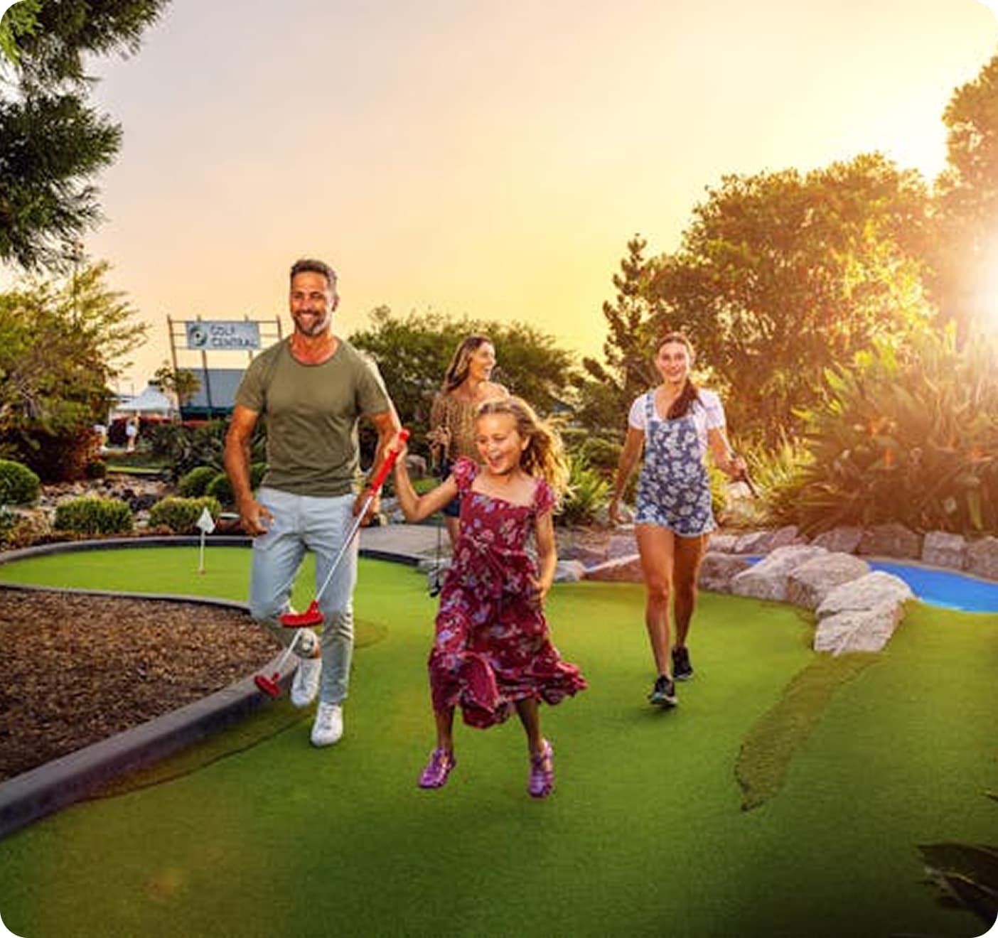 Family playing mini golf