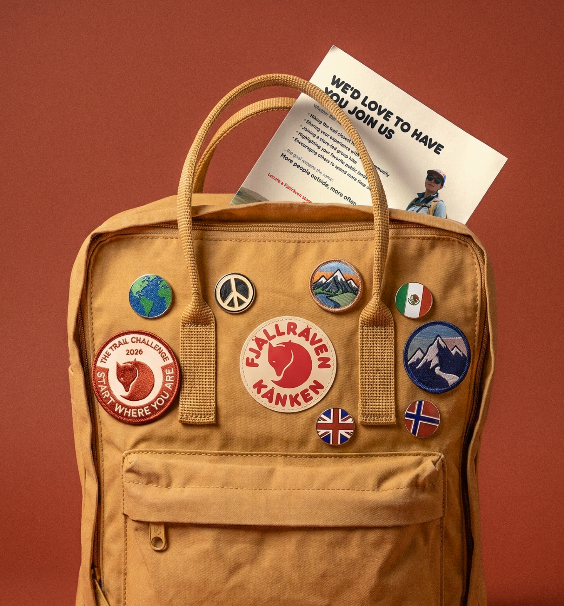 Fjällräven Kanken bag with patches all over and a campaign flyer sticking out