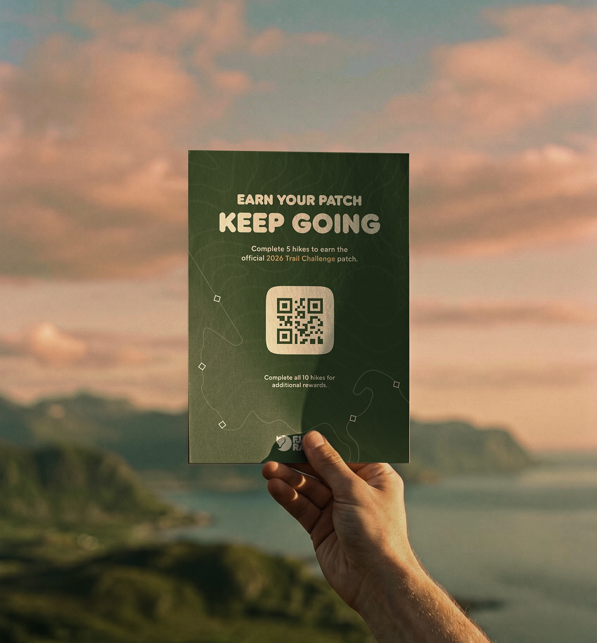 Pin red mobile screen showing the "Earn your patch. Keep going." prompt, held in hand against a warm sky.