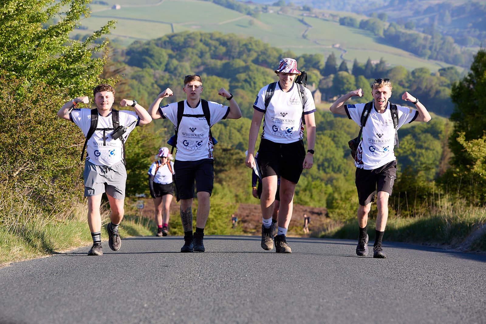 The team hiking together with mountains behind