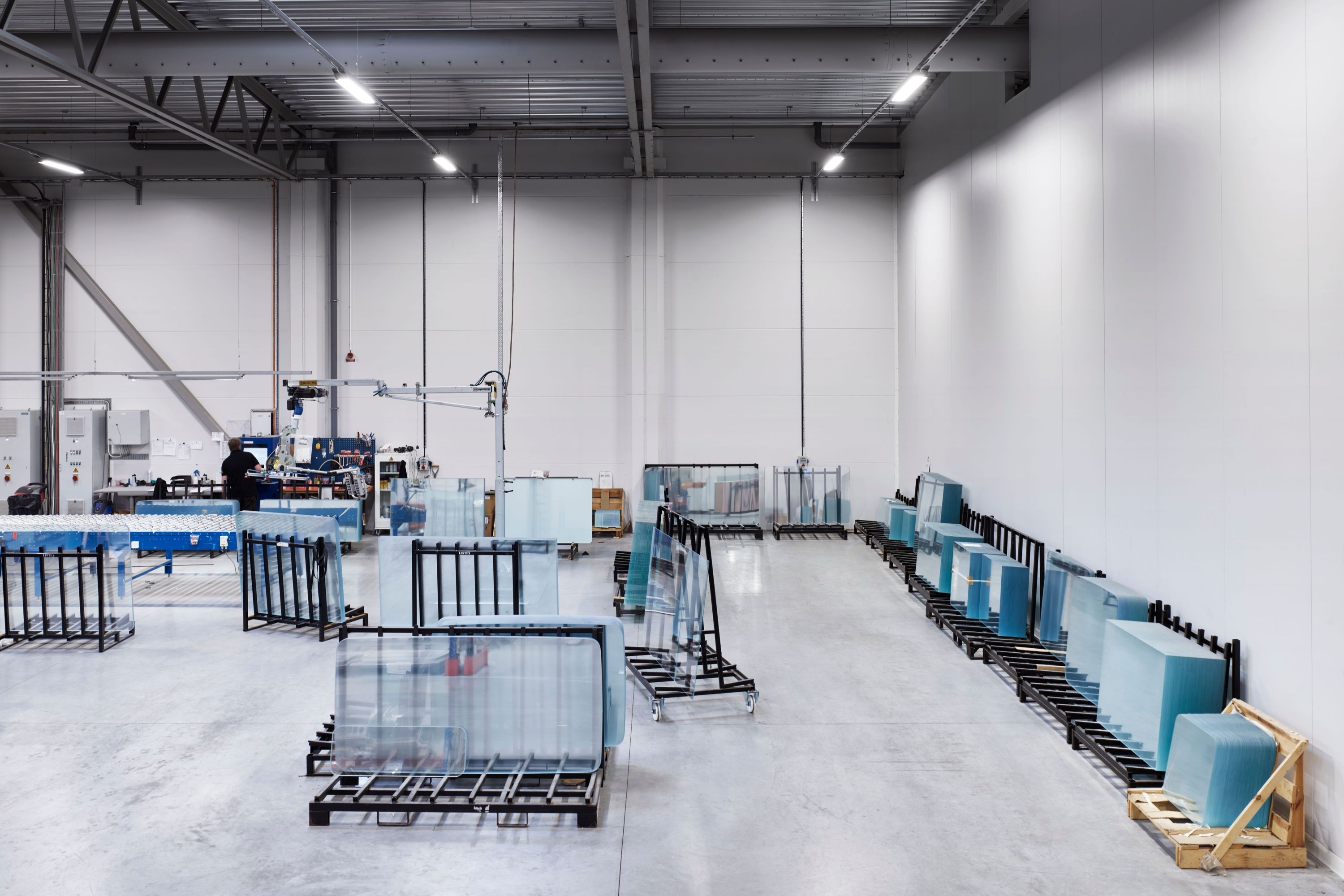 Glass boards in racks in the bright factory hall in Nybro