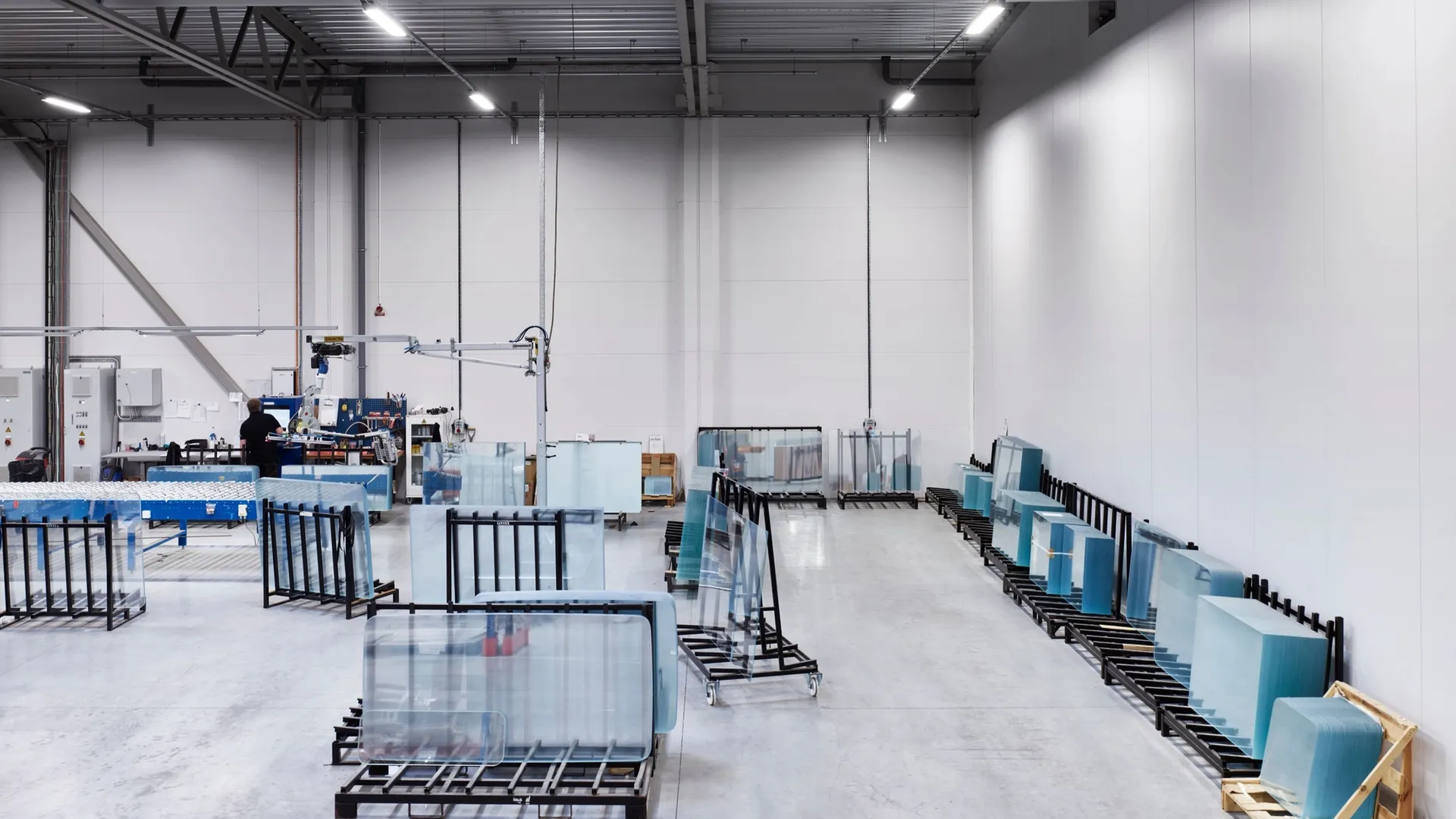 Glass boards in racks in the bright factory hall in Nybro