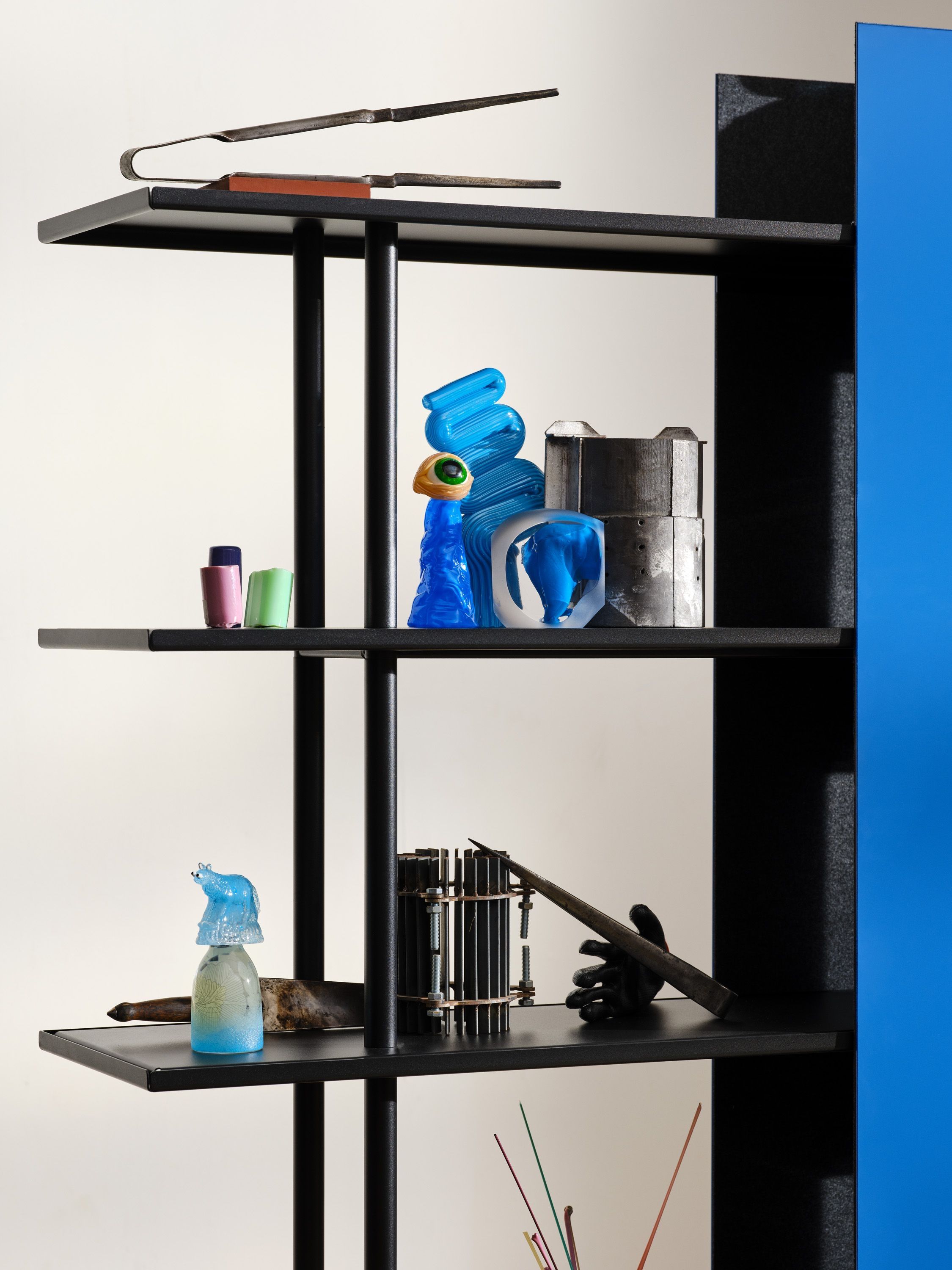 Close-up of blue and clear glass sculptures on an A08 shelf