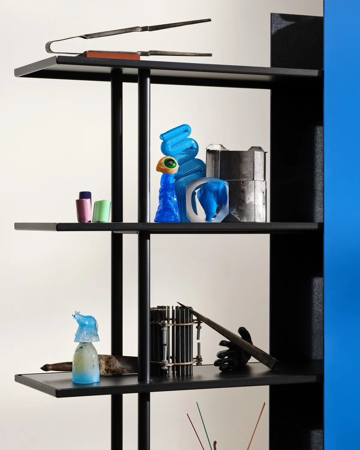 Close-up of blue and clear glass sculptures on an A08 shelf
