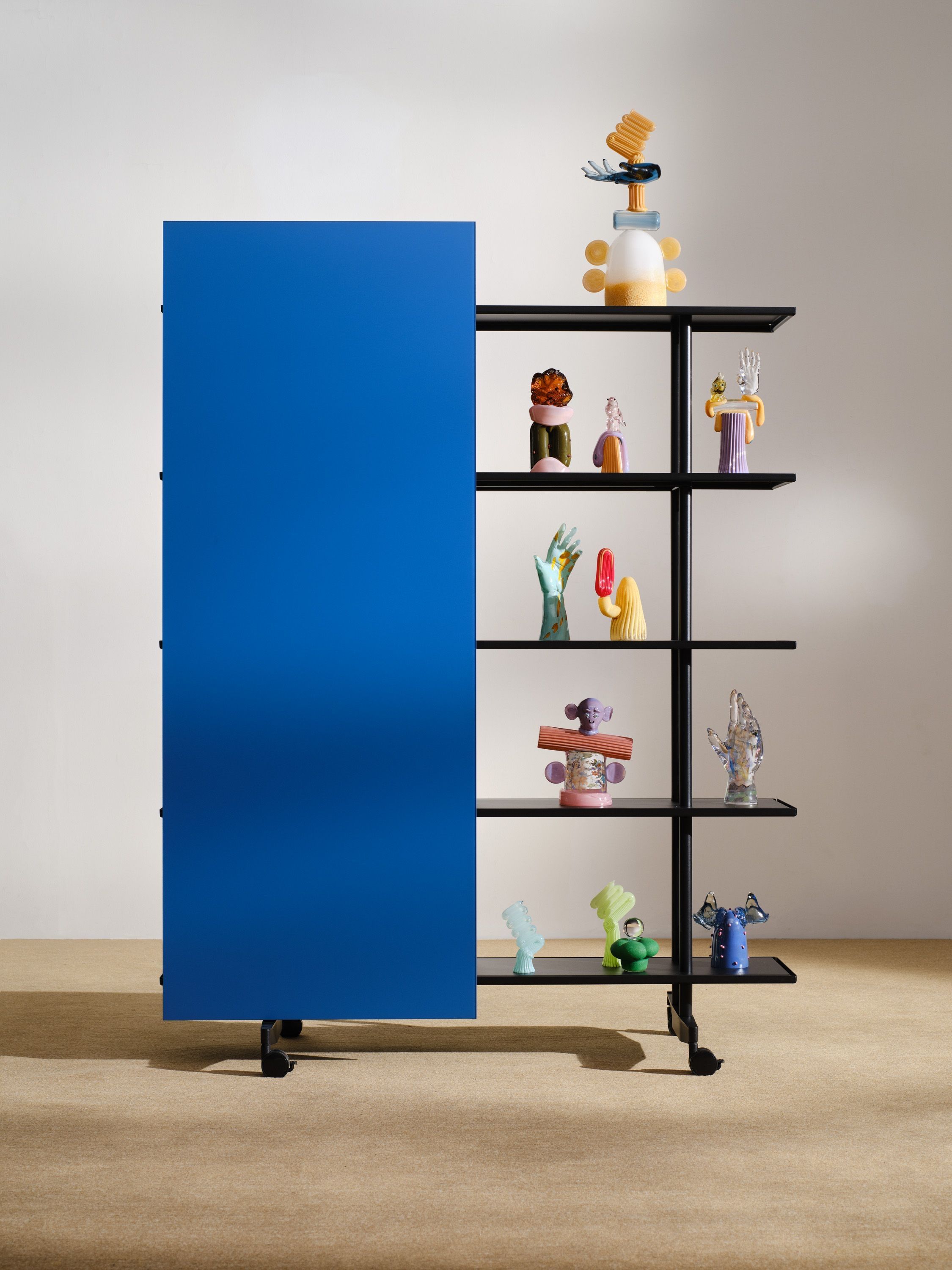 A blue A08 with glass sculptures by Rasmus Nossbring on its shelves