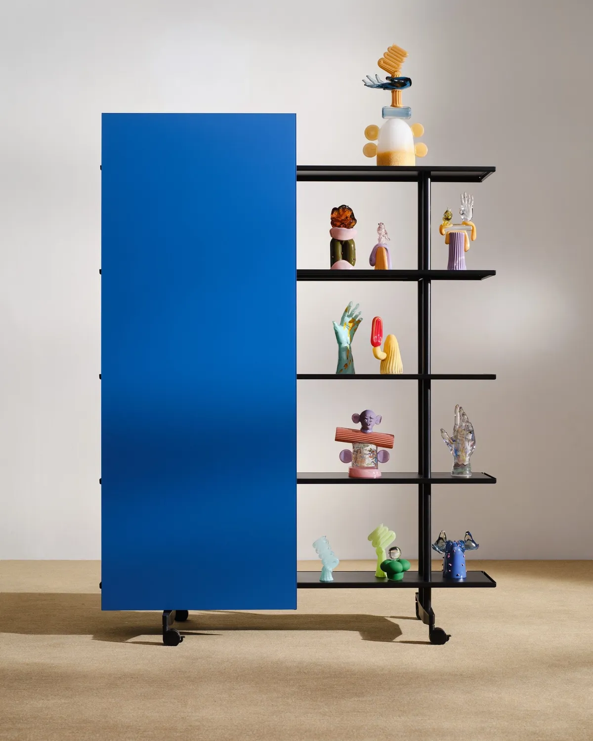 A blue A08 with glass sculptures by Rasmus Nossbring on its shelves