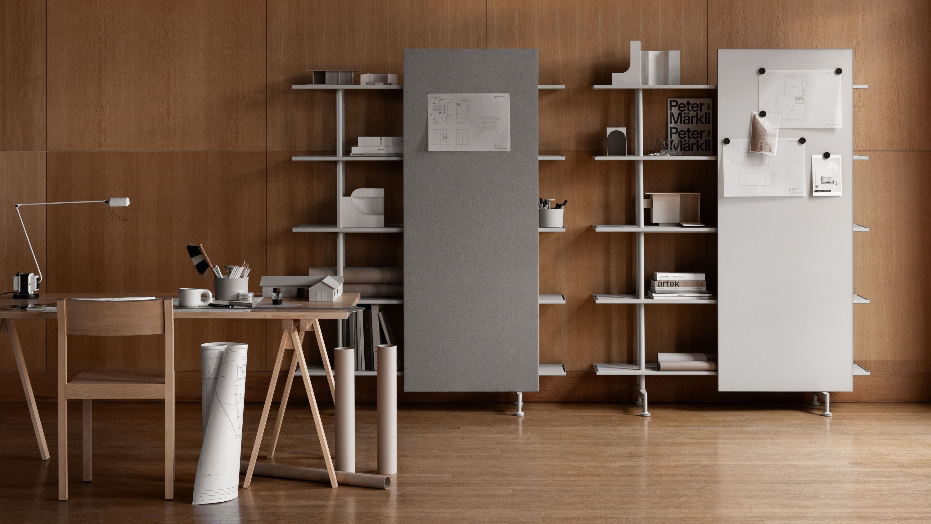 A08 shelving system with a grey noticeboard and a white whiteboard in a studio with wooden panelling, a desk and rolled drawings