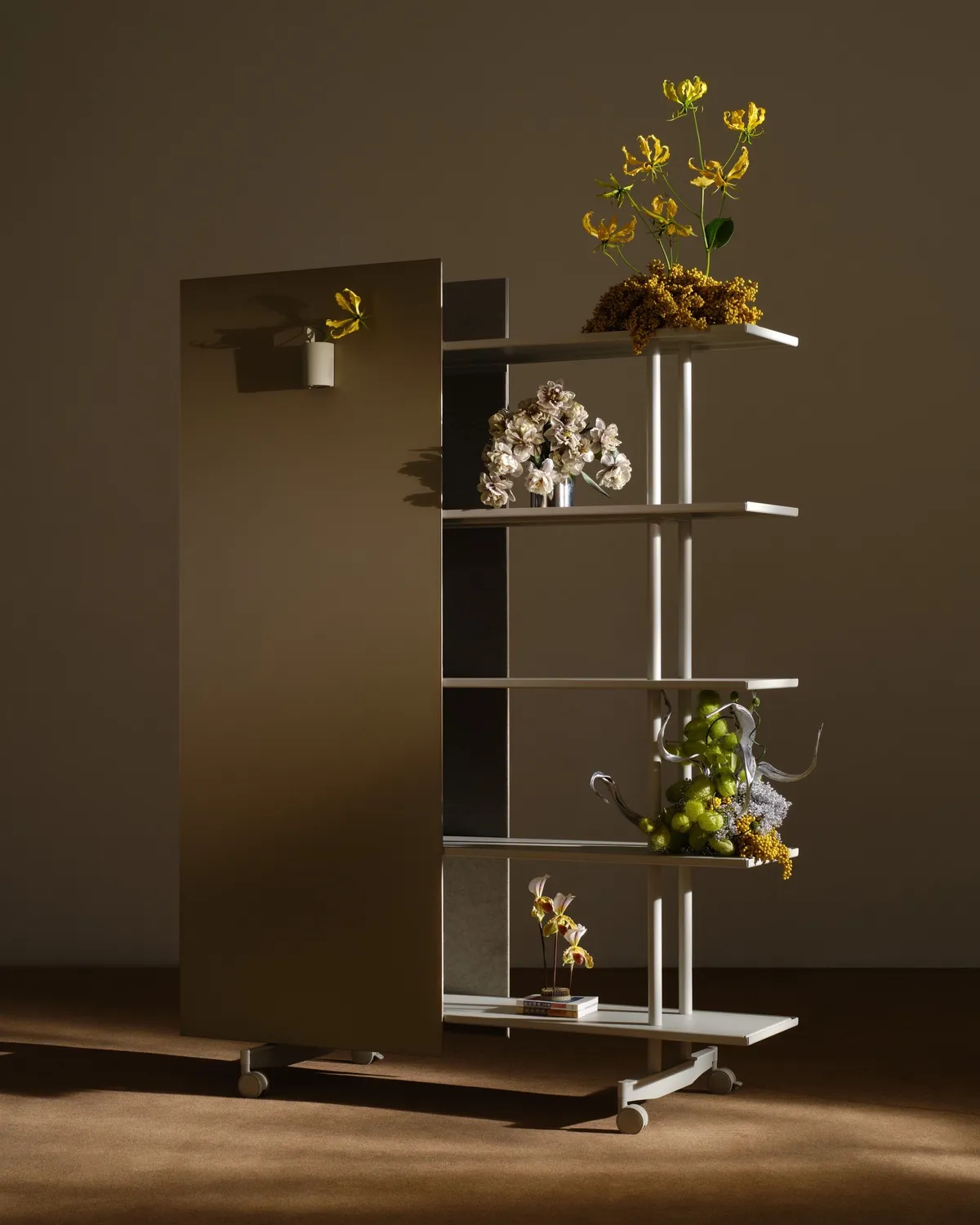 An A08 with a mirrored writing surface and flower arrangements on the shelves