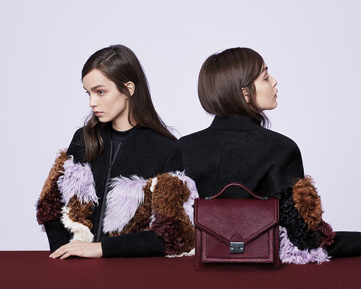 Models wear fringe jacket. Featuring maroon Loeffler Randall purse. Art Direction by RoAndCo