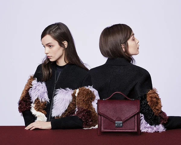 Models wear fringe jacket. Featuring maroon Loeffler Randall purse. Art Direction by RoAndCo