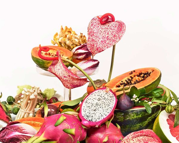 Close up of Sakara's table-scape. Dragonfruit, papaya, figs, and anthurium flowers help showcase clean and beautiful nutrition. Art direction by RoAndCo