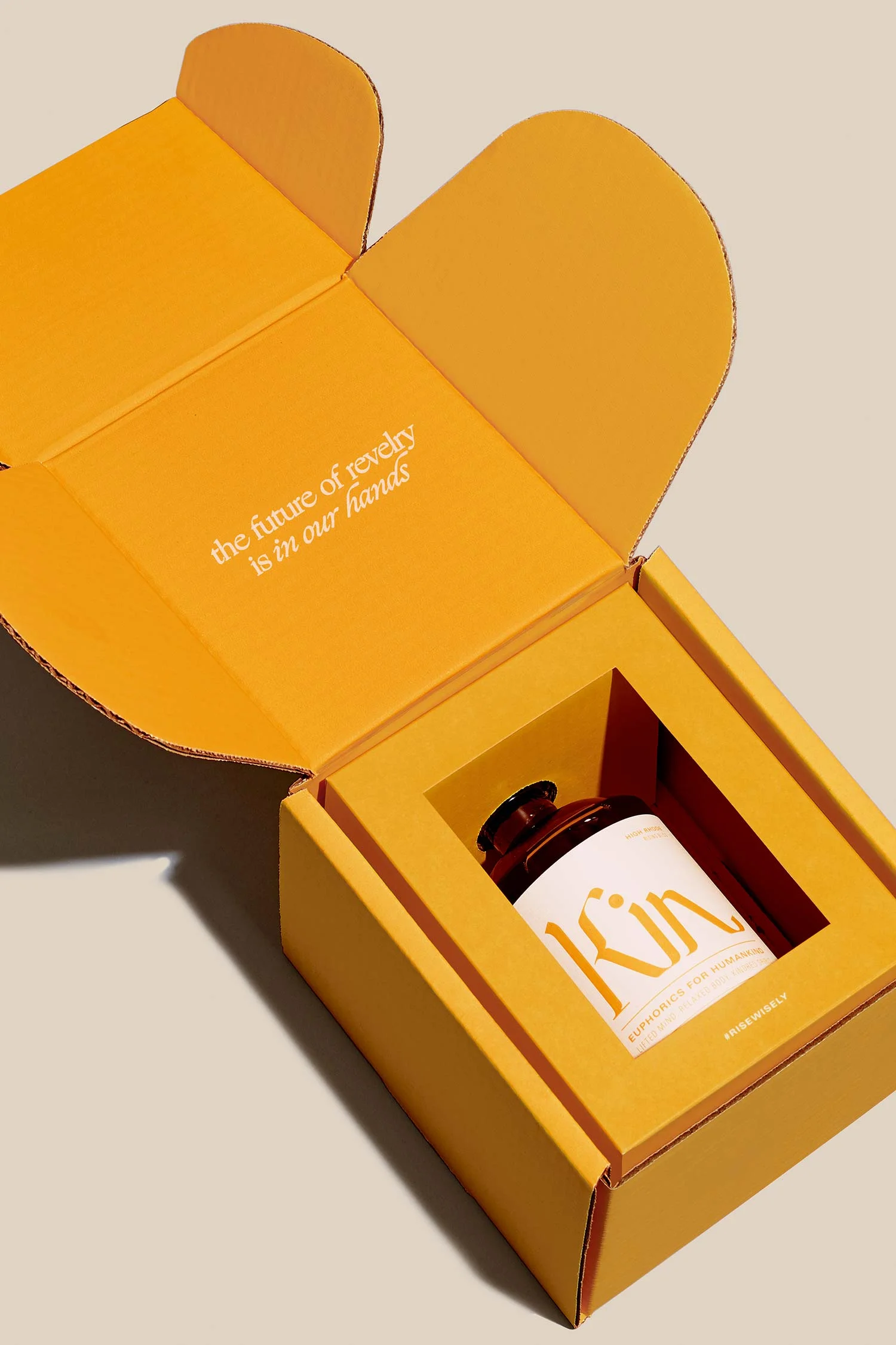 Kin Euphorics Packaging Design by RoAndCo, yellow box with bottle inside