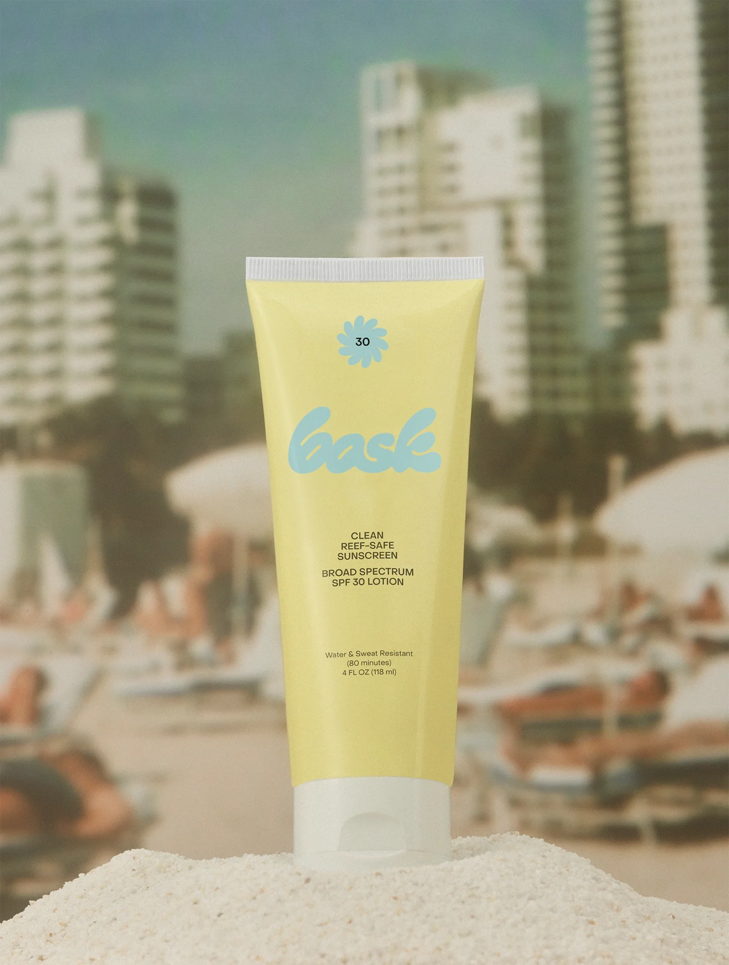 Bask Yellow Lotion Tube on a pile of sand by the Beach - Art Direction by RoAndCo