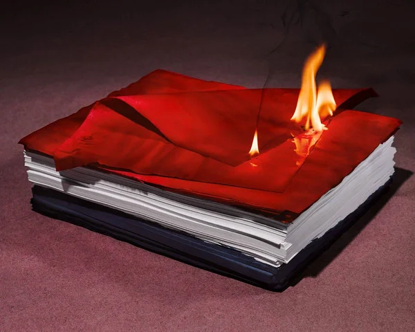 Stack of burning papers for Romance Journal issue 02 Resistance. Publication design, art direction, print design by RoAndCo.