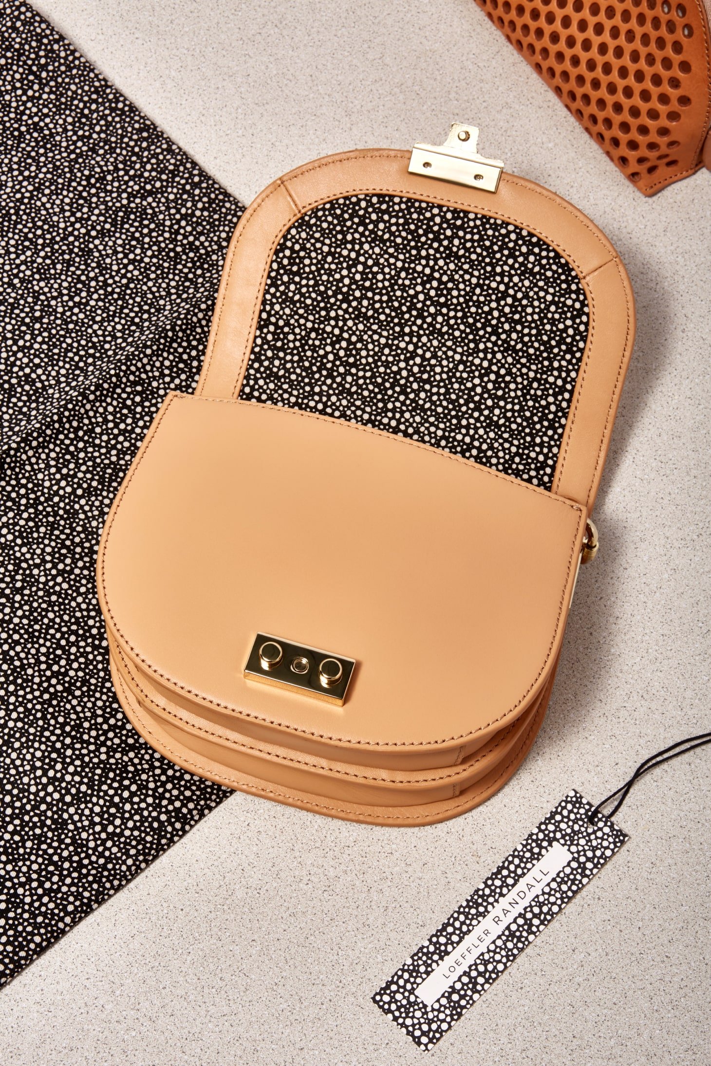 Tan Loeffler Randall purse, featuring hang tag. Branding, Packaging and art direction by RoAndCo