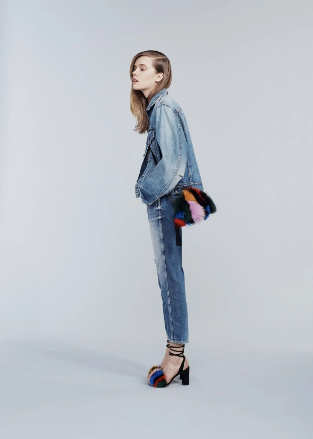 Model wearing jeans and jean jacket with Loeffler Randall peep-toe fur accented heels and matching purse. Art direction by RoAndCo