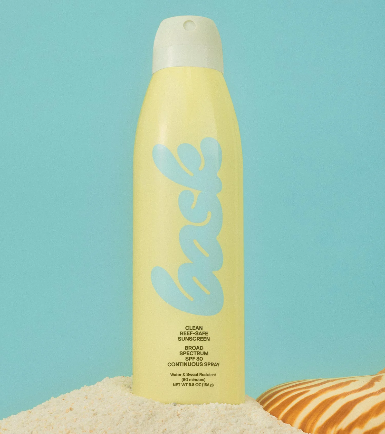 Bask Suncare Yellow Continuous Spray Sunscreen Bottle on Sand with Sea Shell on a Blue Background, Art Direction by RoAndCo