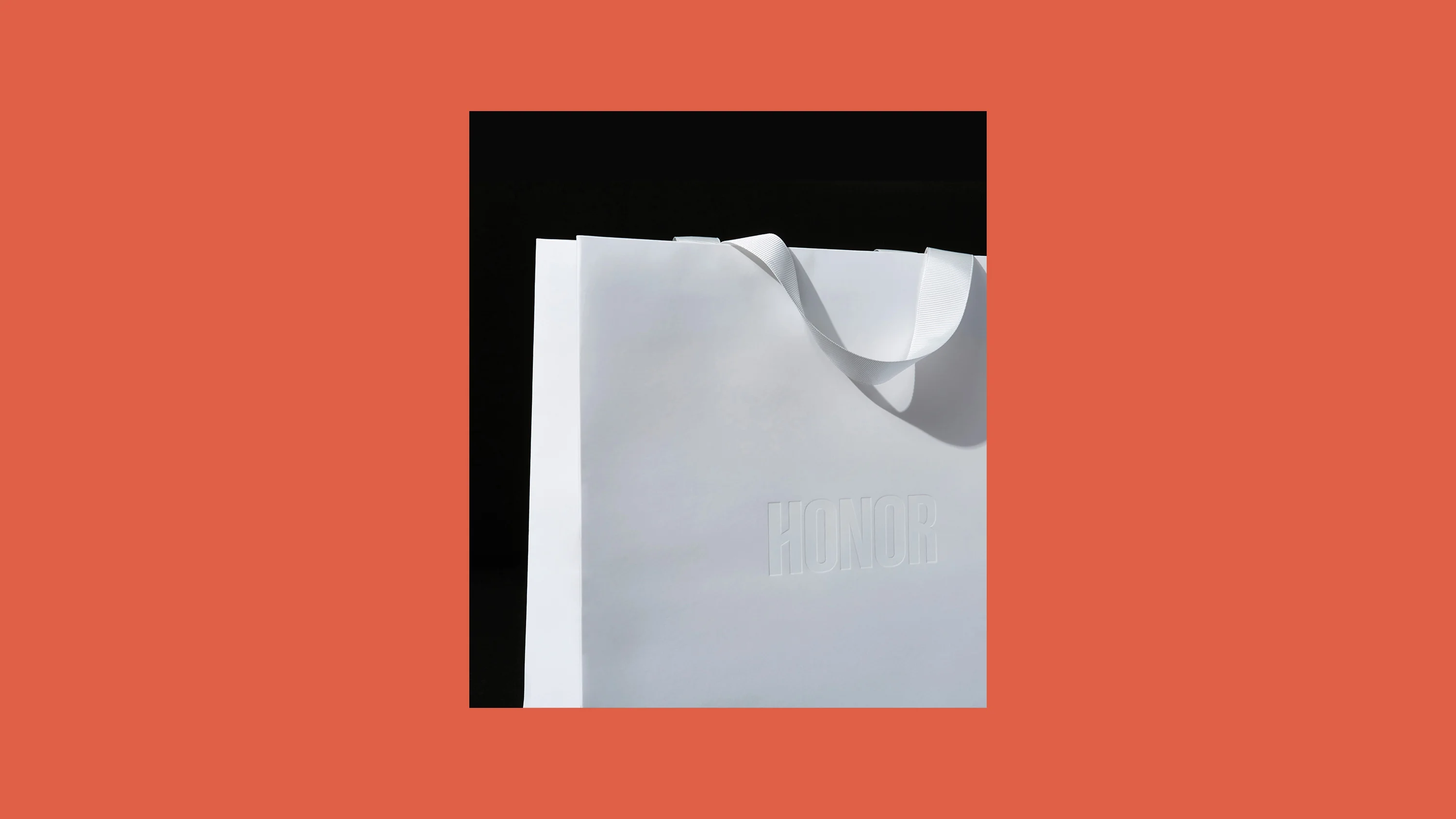 White Honor shopping bag with embossed logo, print design by RoAndCo Studio