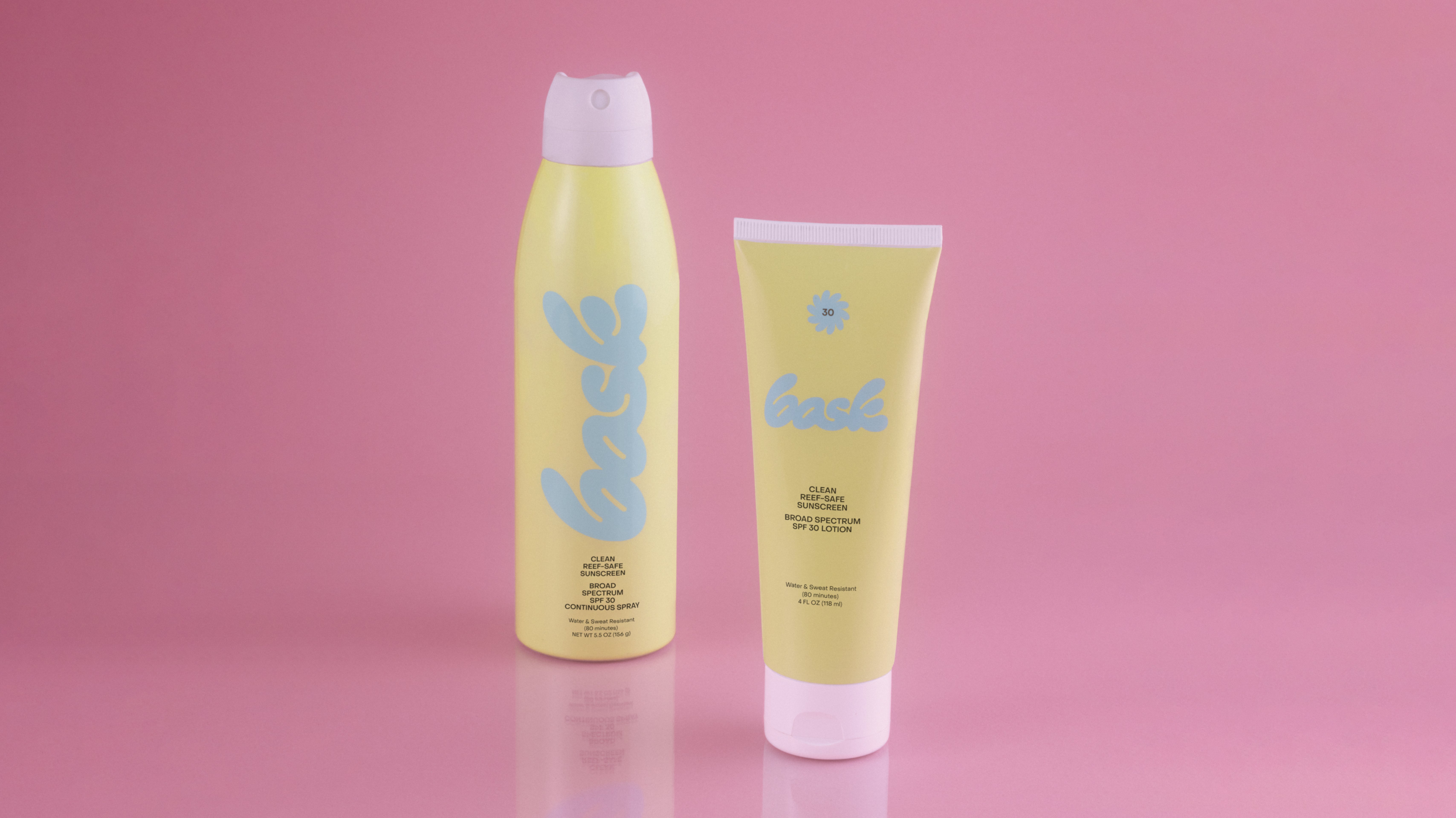 Bask Yellow Continuous Spray and Lotion Tube on a Pink background, branding and packaging design by RoAndCo