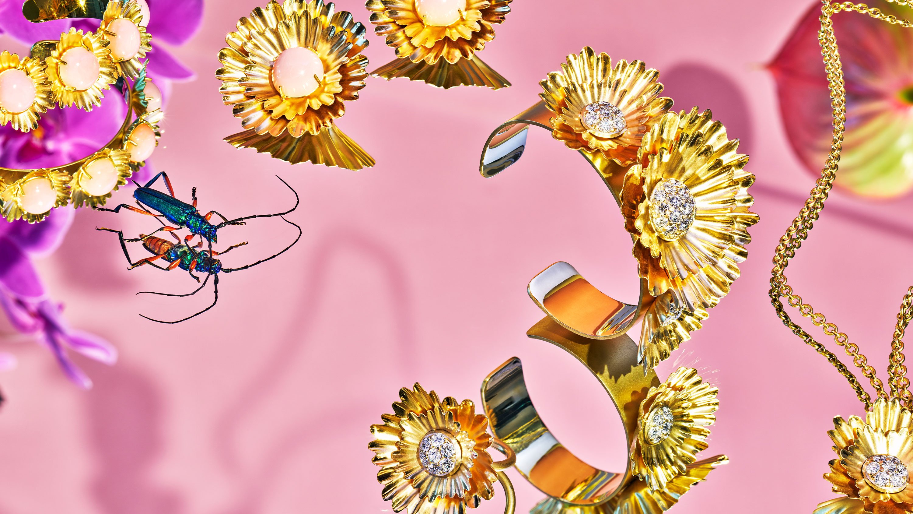 Irene Neuwirth gold super bloom jewelry collection. Gold jewelry with pink background. Art direction by RoAndCo Studio 