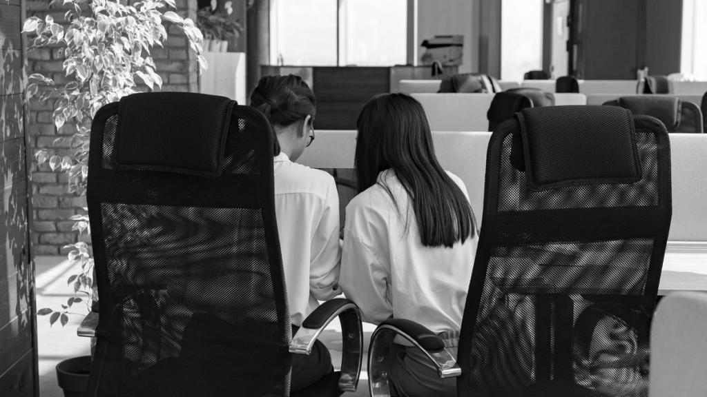 Colleagues working together at desks in an open-plan office