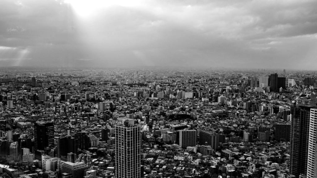 Aerial view of a dense city skyline under an overcast sky