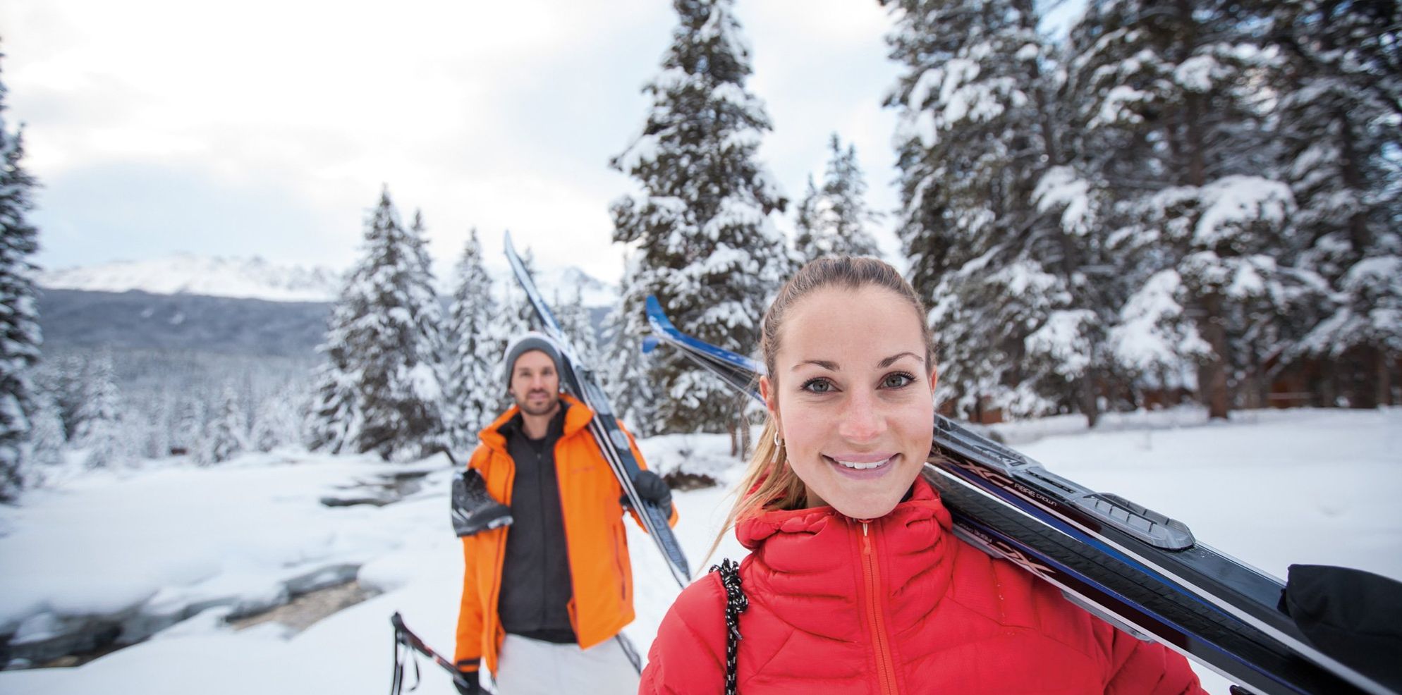 Portrait of a girl carrying cross country skies in Banff and Lake Louise.