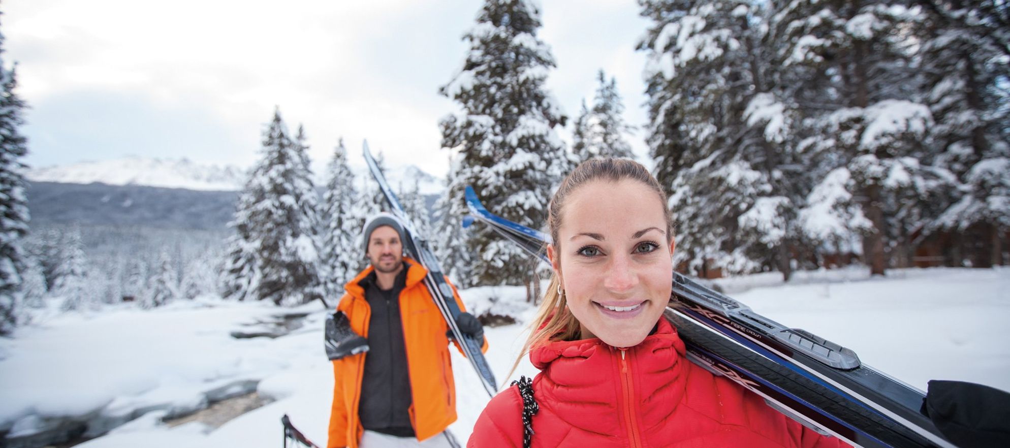 Portrait of a girl carrying cross country skies in Banff and Lake Louise.