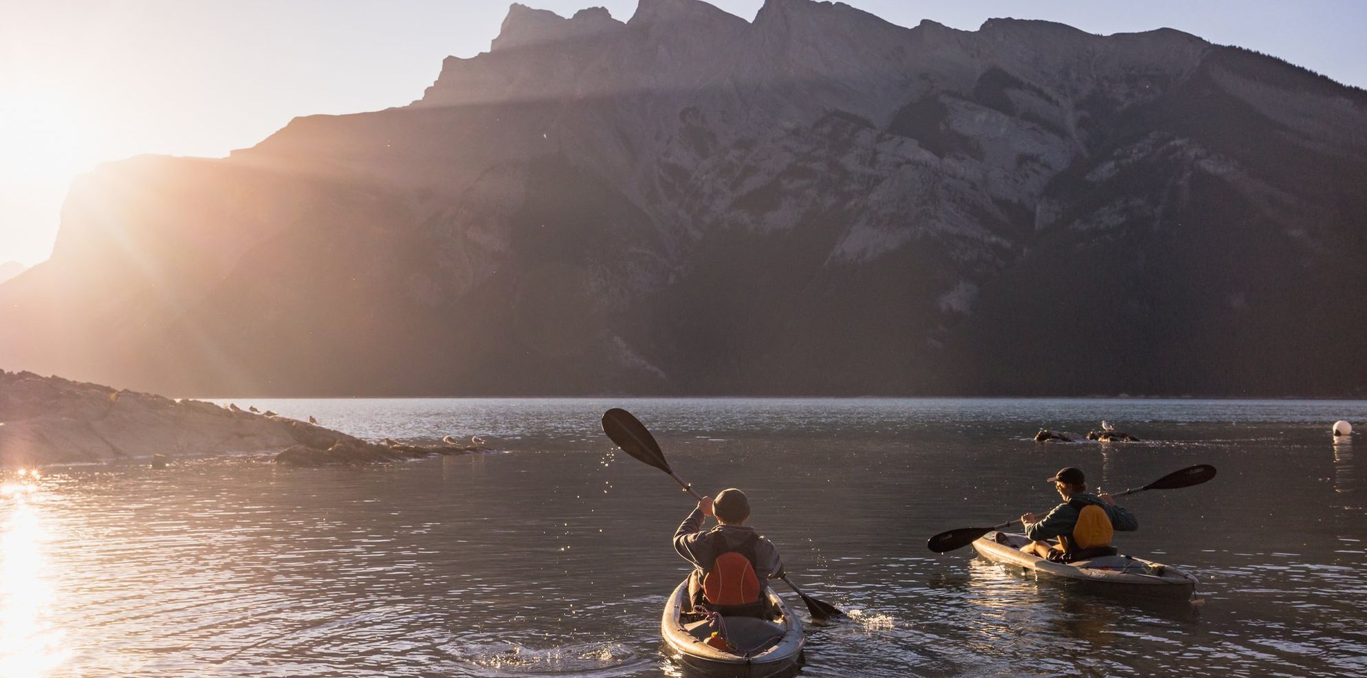 Two kayaks explore Lake Minnewanka in Banff National Park in the Canadian Rockies.