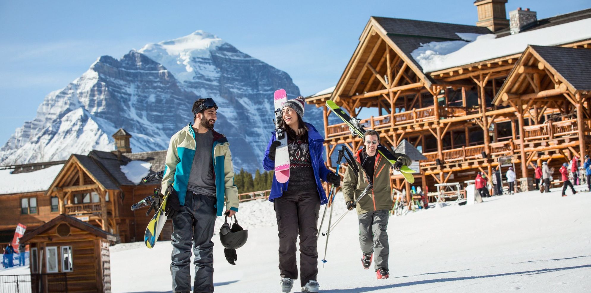 Friends at a ski resort heading toward the chairlift with all their gear