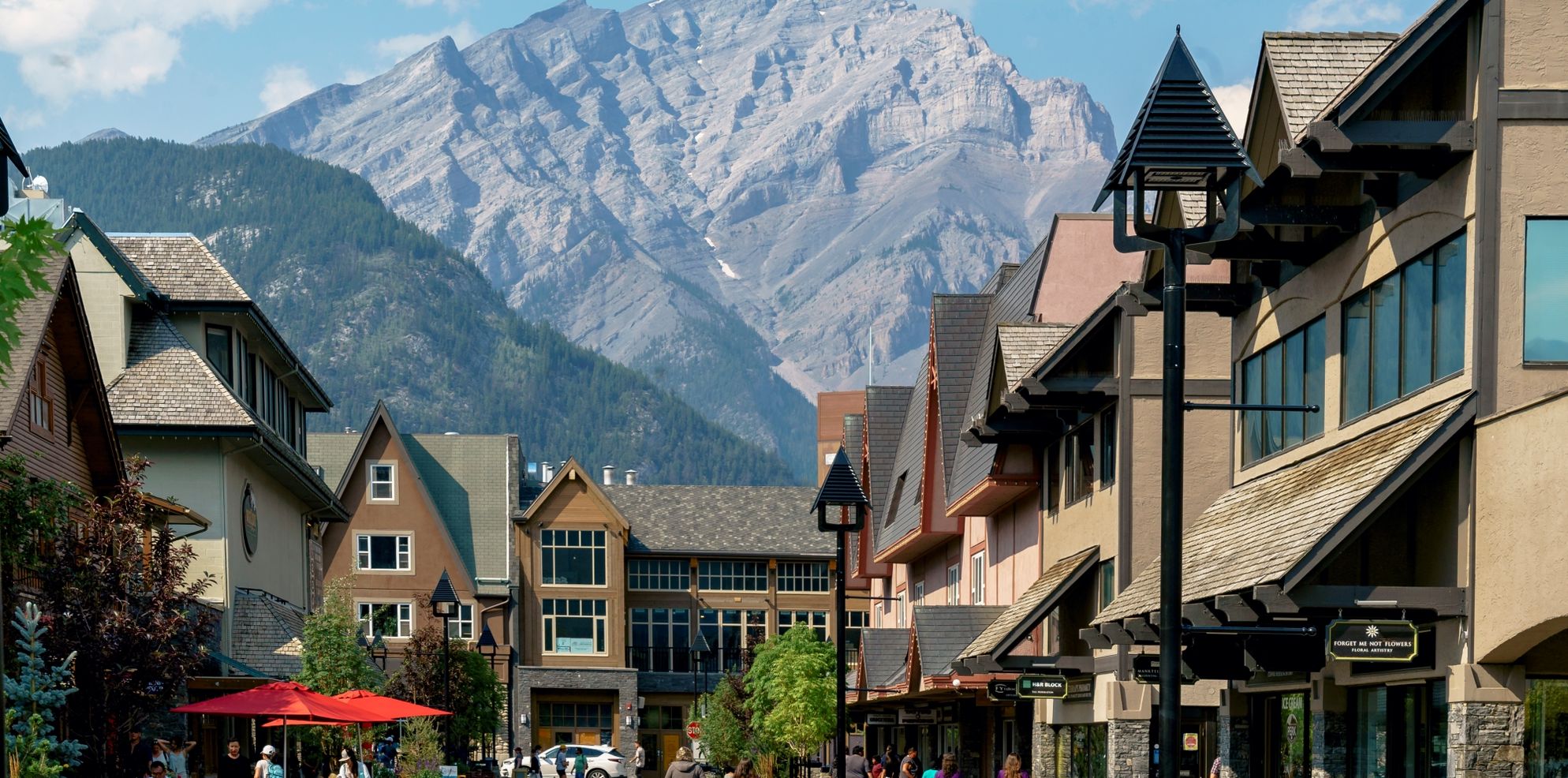 People walk on the new Bear Street in Banff with Cascade Mountain in the background.