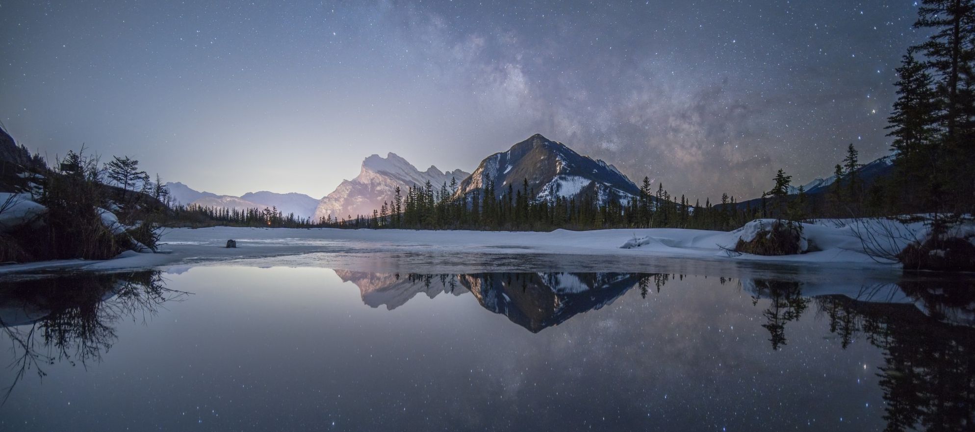 A photo of the stars and milky way over Vermilion Lakes in Banff National Park