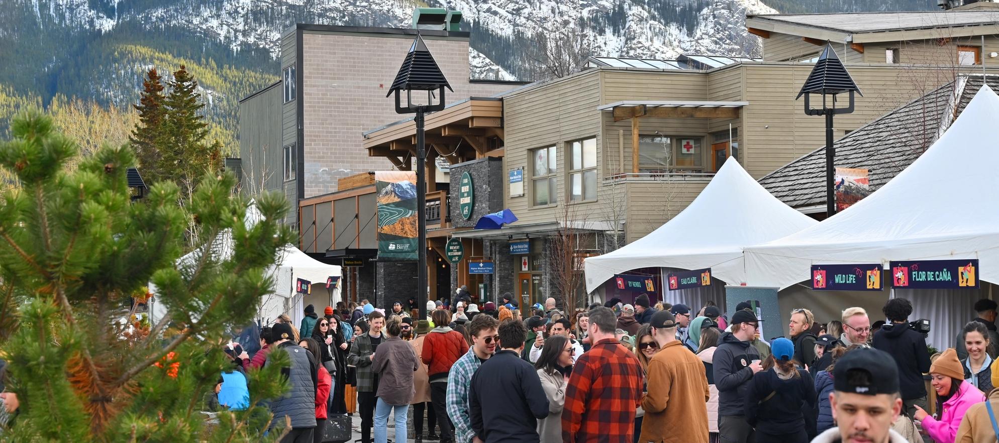 People enjoying cocktails at an outdoor tasting event on bear Street.
