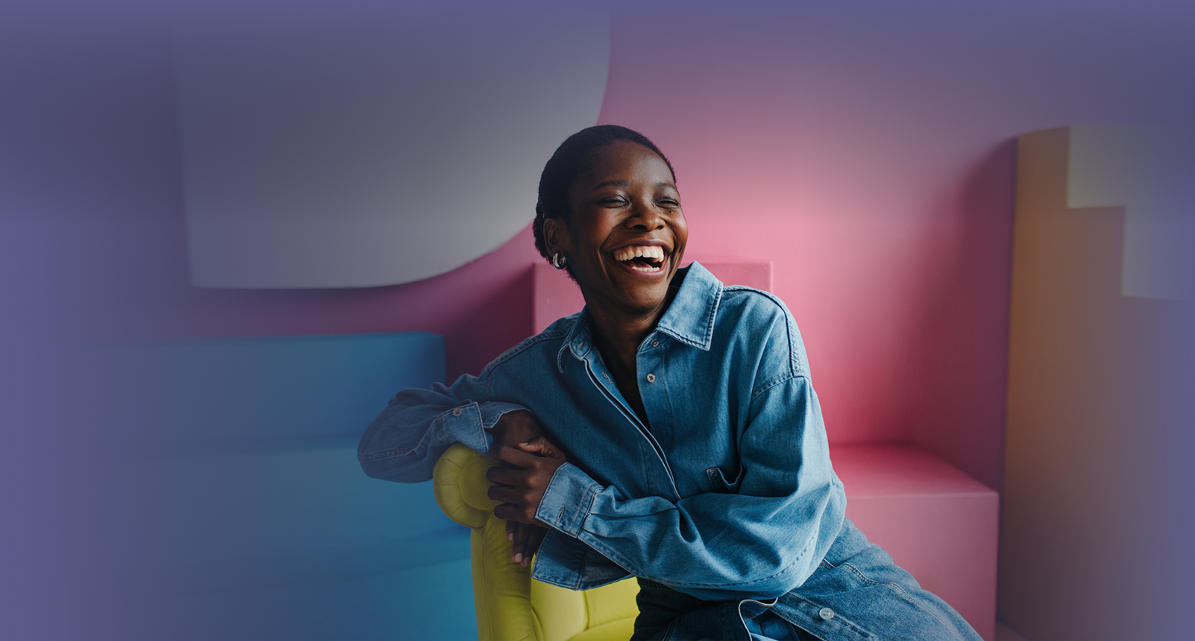 A photo of a woman on a chair laughing