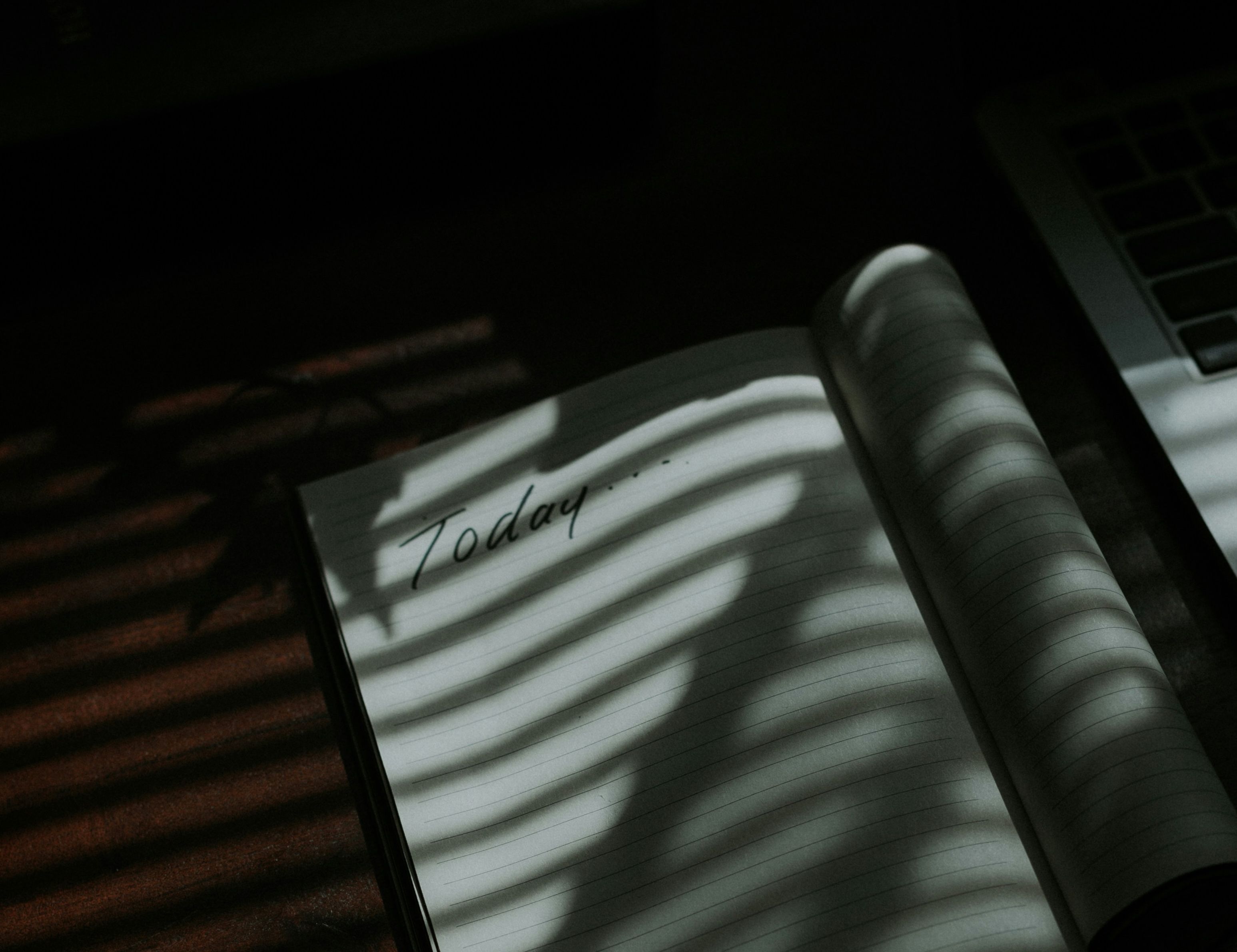 Open notebook with the word ‘today’ written on it