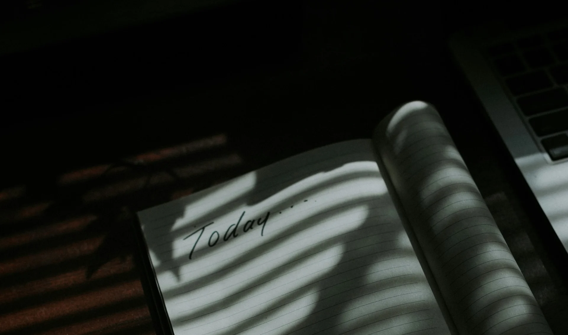 Open notebook with the word ‘today’ written on it