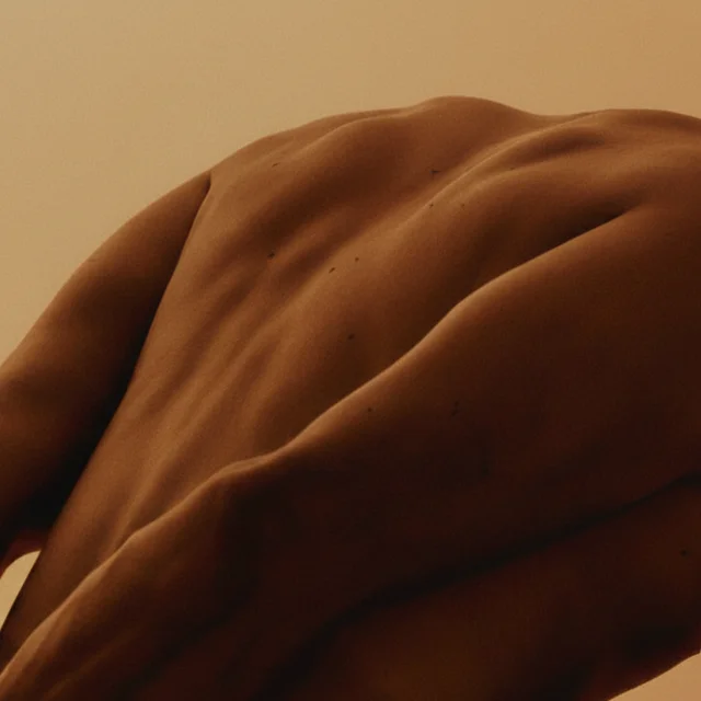 A stretching man on a beige background