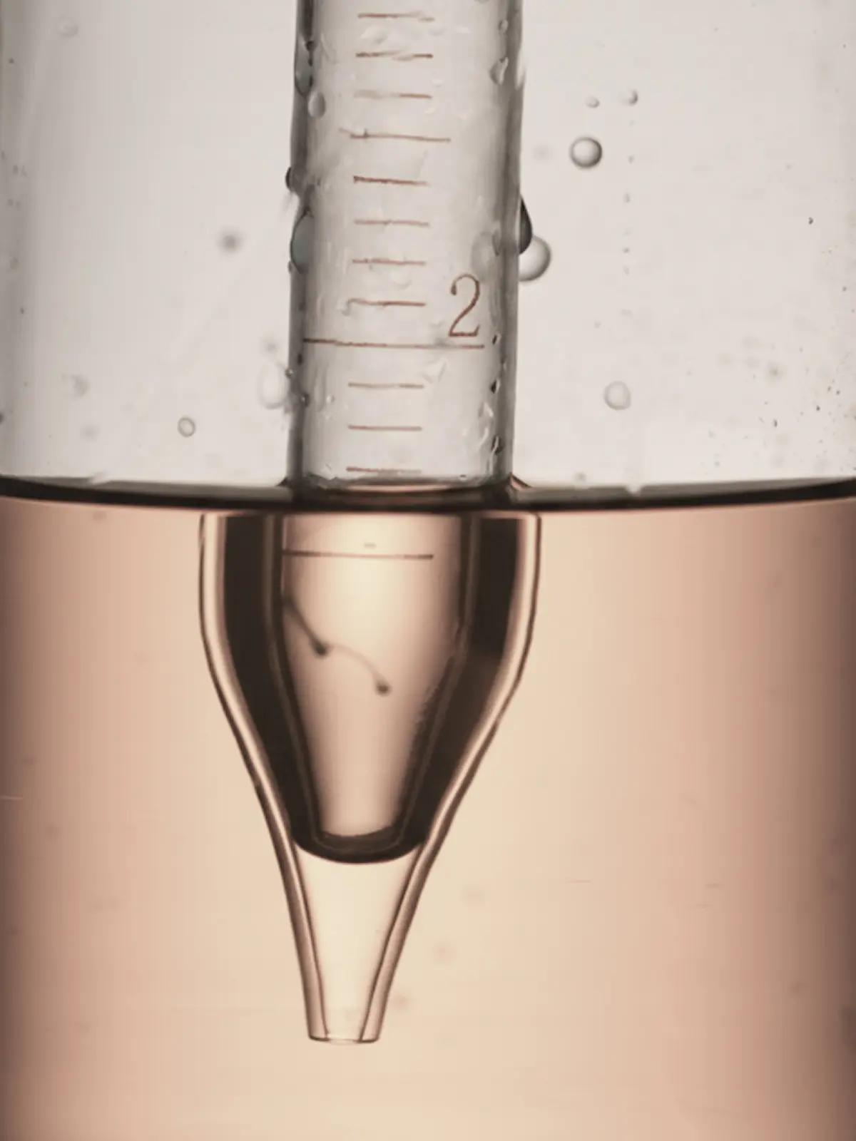 Measuring cup filled with liquid - Longevity & Rejuvenation